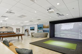 a game room with a pool table and a large window